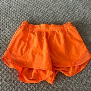 Lululemon shorts size 8 low rise 4 inch shorts. Neon orange color worn lightly